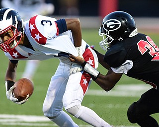 GIRARD, OHIO - AUGUST 27, 2015: Receiver Jasson Faison #3 of Niles attempts to break free from defensive back Collin Harden #39 of Girard during the 1st half of their football game Thursday night at Arrowhead Stadium. DAVID DERMER | THE VINDICATOR