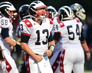 GIRARD, OHIO - AUGUST 27, 2015: Quarterback Tyler Srbinovich #13 of Niles flexes in celebration after scoring on a two point conversion during the 1st half of their football game Thursday night at Arrowhead Stadium. DAVID DERMER | THE VINDICATOR