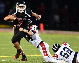 GIRARD, OHIO - AUGUST 27, 2015: Quarterback Mark Waid #7 of Girard is sacked by Ricky Palmer #14 and Alex Clementi #52 of Niles during the 1st half of their football game Thursday night at Arrowhead Stadium. DAVID DERMER | THE VINDICATOR