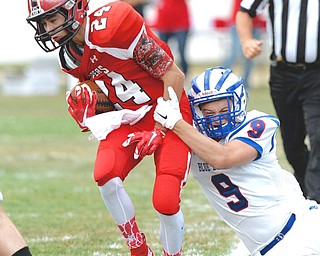 Jeff Lange | The Vindicator  AUGUST 27, 2014 - Columbiana's Cooper Smith is tackled out of bounds by Reserve's Jeep DiCioccio early in the first quarter of their game, Thursday night in Columbiana.