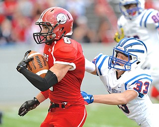Jeff Lange | The Vindicator  AUGUST 27, 2014 - Columbiana's Jacob Ward (6) evades the tackle of Western Reserve's Cole Chlebus (33) as he runs for a touchdown in the second quarter of their game on Thursday night in Columbiana.