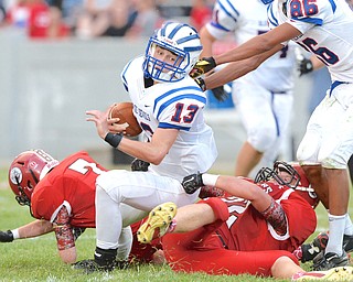 Jeff Lange | The Vindicator  AUGUST 27, 2014 - Blue Devils' quarterback Wyatt Larimer (13) is tackled just short of the goal line by Clippers' Keenan Green late in the first half of their Thursday-night game at Firestone Stadium in Columbiana.