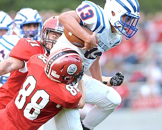 Jeff Lange | The Vindicator  AUGUST 27, 2014 - Western Reserve quarterback Wyatt Larimer (13) attempts to jump past the tackle of Clippers' Connor Stacey (88) late in the second quarter of their game on Thursday night in Columbiana.