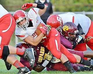 Jeff Lange | The Vindicator  AUGUST 28, 2015 - Struthers Jose Perez is brought down at the line by a host of Leopard defenders early in the first quarter of Friday night's game in Liberty.