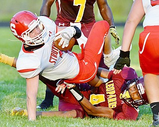 Jeff Lange | The Vindicator  AUGUST 28, 2015 - Liberty's Kaylon Davis (4) pulls down Struthers Dakota Senvisky during first half action of their game, Friday night in Liberty.