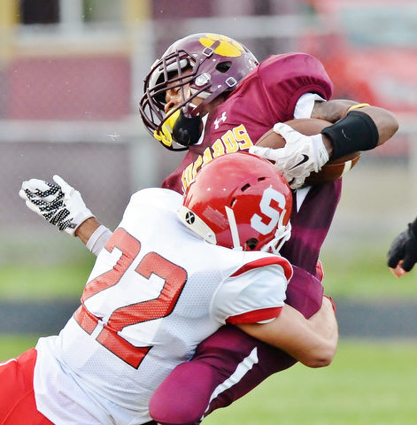 Jeff Lange | The Vindicator  AUGUST 28, 2015 - Leopards' Khyri Davis is tackled by Struthers' Jose Perez (22) after a short gain in the first half of their Friday-night game in Liberty.