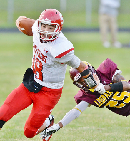Jeff Lange | The Vindicator  AUGUST 28, 2015 - Struthers' AJ Musolino (18) sheds Leopard defender Khyri Davis as he runs out of bounds after a short gain in the first half of their game on Friday night in Liberty.