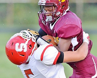 Jeff Lange | The Vindicator  AUGUST 28, 2015 - Liberty's Dra Rushton (top) collides with Struthers defender Trent Stocker after a short gain in the first half of their game, Friday night in Liberty.