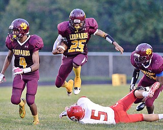 Jeff Lange | The Vindicator  AUGUST 28, 2015 - Liberty's Khyri Davis (25) leaps over Struthers' Trent Stocker (5) as teammates Kaylon Davis (4) and Chris Edmonds trail the play from behind in the second quarter of their game, Friday night in Liberty.