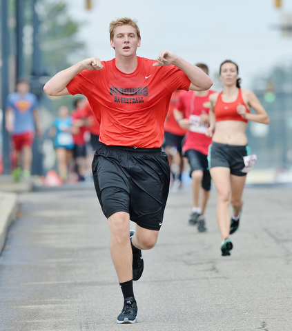 Jeff Lange | The Vindicator AUGUST 30, 2015 - YSU mens' basketball forward Bobby Hain jogs down Front Street toward the finish line at the Covelli Centre during Sunday's Panerathon.