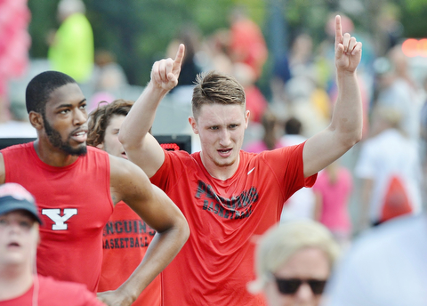 Jeff Lange | The Vindicator AUGUST 30, 2015 - YSU junior basketball player Matt Donlan (center) raises his arms in victory as he crosses the finish line of Sunday's Panerathon 2 mile run at the Covelli Centre.