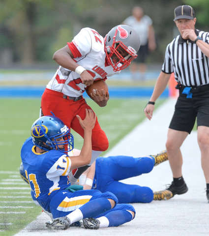 Jeff Lange | The Vindicator  AUGUST 29, 2015 - Labrae's Arjay Oliver is tackled out of bounds by Valley Christian's Marcus Roman (bottom) during first quarter action of their game, Saturday night in Poland.