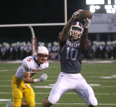       .         ROBERT  K. YOSAY | THE VINDICATOR..Mooneys #5 Mike WIlliams can only watchas Boardmans #10  Travis Koontz hauls in a short pass for Boardmans First .. first and ten....Boardman Spartan New Stadium as Cardinal Mooney  ..-30-