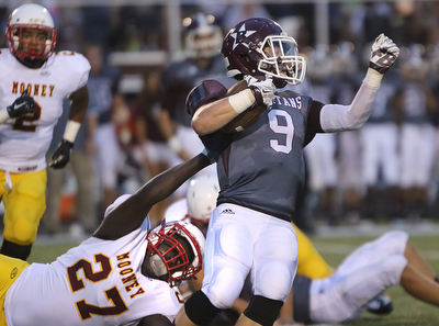       .         ROBERT  K. YOSAY | THE VINDICATOR..Mooneys #27  Jaylen Hewlett  stretches and grabs the jersey of Boardmans #9  Gaven Strines  for a loss in the backfield..Boardman Spartan New Stadium as Cardinal Mooney  ..-30-