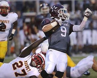       .         ROBERT  K. YOSAY | THE VINDICATOR..Mooneys #27  Jaylen Hewlett  stretches and grabs the jersey of Boardmans #9  Gaven Strines  for a loss in the backfield..Boardman Spartan New Stadium as Cardinal Mooney  ..-30-