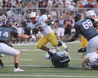       .         ROBERT  K. YOSAY | THE VINDICATOR..Mooneys #2 Cleveland Gruber Hurdles a boardman defender as #44 for Boardman  Nick Patoray and #66 Wes Thompson  try to bring him down during first quarer action..Boardman Spartan New Stadium as Cardinal Mooney  ..-30-