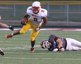       .         ROBERT  K. YOSAY | THE VINDICATOR..Mooneys #8  Ray Anerson Breaks a tackle by Boardmans #44  Nick Patoray as he leaves the backfield during first quarter action..Boardman Spartan New Stadium as Cardinal Mooney  ..-30-
