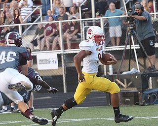       .         ROBERT  K. YOSAY | THE VINDICATOR..Mooneys #9  David McDowell  sprints past Boardmans #46 Mike Melewski can only watch as McDowell Sprints 12 yards for Boardmans First TD in the first quarter..Boardman Spartan New Stadium as Cardinal Mooney  ..-30-