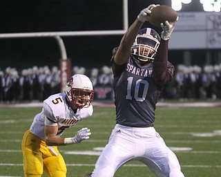       .         ROBERT  K. YOSAY | THE VINDICATOR..Mooneys #5 Mike WIlliams can only watchas Boardmans #10  Travis Koontz hauls in a short pass for Boardmans First .. first and ten....Boardman Spartan New Stadium as Cardinal Mooney  ..-30-