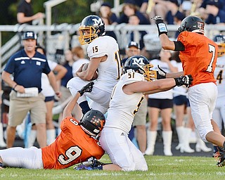Jeff Lange | The Vindicator  SEPTEMBER 4, 2015 - McDonald's Joe Perry (15) is brought down by Springfield's Zach Barber (9) as McDonald's Hunter Kutsch (51) tackles Springfield's Jake Ford during first quarter action at Springfield High School, Friday night.