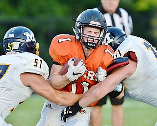 Jeff Lange | The Vindicator  SEPTEMBER 4, 2015 - Springfield's Frankie Centofanti (center) winces in pain as he is crushed between McDonald's Calvin Wolford (left) and Drew Butler (right) in the second quarter of their game on Friday night in Springfield.