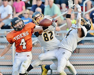 Jeff Lange | The Vindicator  SEPTEMBER 4, 2015 - Springfield WR Cody Allen (4) gets his hand on the ball under heavy pressure from McDonald's Joe Sudol (82) and Joey Celli (right) during second quarter action in Springfield. Allen made the catch and took it to the end zone for Springfield's first touchdown to make the score 6-7.