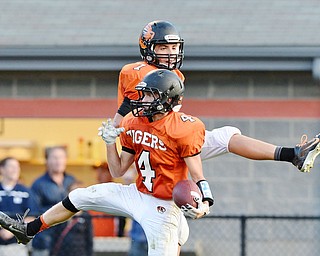 Jeff Lange | The Vindicator  SEPTEMBER 4, 2015 - Tigers' Cody Allen (4) celebrates in the end zone with teammate Jake Ford (7) after Allen caught a 35 yard pass for a touchdown in the second quarter of Springfield's game against McDonald on Friday night at Springfield High School.