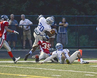 Katie Rickman | The Vindicator.Hubbard's Brandon Rios #20 scores a touchdown during the first half of the game against Girard's Collin Hardin #39 moments before a lightning delay was called during the second quarter Friday Sept. 4, 2015.