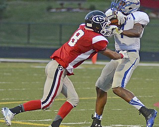 Katie Rickman | The Vindicator.Hubbard's George Hill #4 attempts to get past Girard's Anthony Backus #8 during the game at Arrowhead Stadium Friday Sept. 4, 2015.