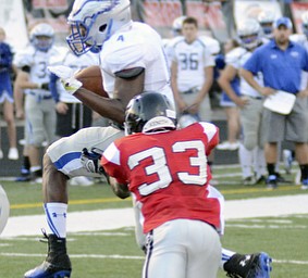 Katie Rickman | The Vindicator.Hubbard's  George Hill #4 gets past Girard's  Jamil Bannister #33 to score a goal during the first half of the  game at Arrowhead Stadium Friday Sept. 4, 2015.