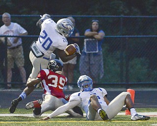 Katie Rickman | The Vindicator.Hubbard's Brandon Rios #20 scores a touchdown during the first half of the game against Girard's Collin Hardin #39 moments before a lightning delay was called during the second quarter Friday Sept. 4, 2015.