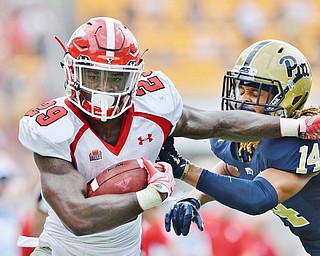 Jeff Lange | The Vindicator  SEPTEMBER 5, 2015 - Youngstown State University's Martin Ruiz (29) rushes past the tackle of Pitt's Avonte Maddox (14) in the first quarter of their game, Saturday at Heinz Field.