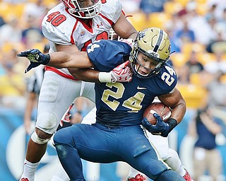 Jeff Lange | The Vindicator  SEPTEMBER 5, 2015 - Pitt's James Conner (24) rushes with the ball as YSU's Jaylin Kelly (40) tackles him from above during Saturday's game at Heinz Field.