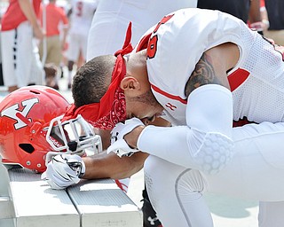 Jeff Lange | The Vindicator  SEPTEMBER 5, 2015 - YSU's Darien Townsend has a pre-game prayer at the bench before the start of Saturday's game against Pitt at Heinz Field.