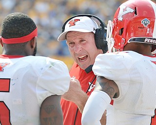 Jeff Lange | The Vindicator  SEPTEMBER 5, 2015 - YSU head coach Bo Pelini (center) strategizes with his players Demond Hymes (5) and Eric Thompson (1) in the second half of Saturday's game against Pitt at Heinz Field.