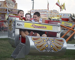 Katie Rickman | The Vindicator.l-r.Vincent Willock 7 of Salem yells as he and  Ryan Eicher 9 of Canfield and his brother Victor Willock 9 ride the "Scrambler" at the Canfield Fair on Sept 3, 2015.