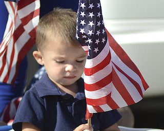 Katie Rickman | The Vindicator.Shane Cleckner 5 of Austintown holds an American Flag as he attended the Mahoning Valley 9-11 Memorial Ceremony with his family at the 9-11 Memorial Park on Raccoon Road on September 11, 2015.