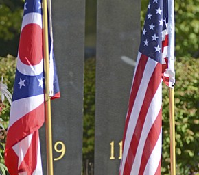 Katie Rickman | The Vindicator.Flags fly in front of the memorial of the twin towers during the Mahoning Valley 9-11 Memorial Ceremony held at the 9-11 Memorial Park on Raccoon Road on September 11, 2015.