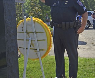 Katie Rickman | The Vindicator.Sgt. Jeff Toth (also a D.A.R.E officer at Austintown Fitch Middle School) salutes after placing a wreath at the "Heroes" memorial during the Mahoning Valley 9-11 Memorial Ceremony at the 9-11 Memorial Park on Racoon Road on September 11, 2015.