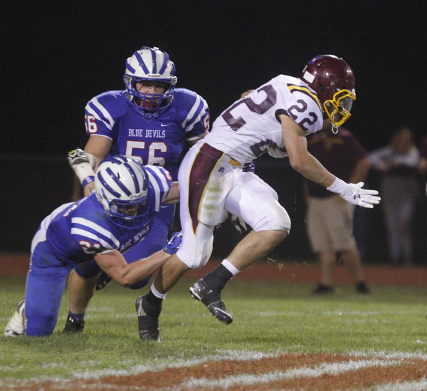       .         ROBERT  K. YOSAY | THE VINDICATOR..Raiders #22   Ethan Dominquez tries to elude 321 Blue Devil Ed Smith and #56  T J Henry..South Range at Western Reserve ...-30-