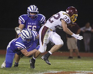       .         ROBERT  K. YOSAY | THE VINDICATOR..Raiders #22   Ethan Dominquez tries to elude 321 Blue Devil Ed Smith and #56  T J Henry..South Range at Western Reserve ...-30-