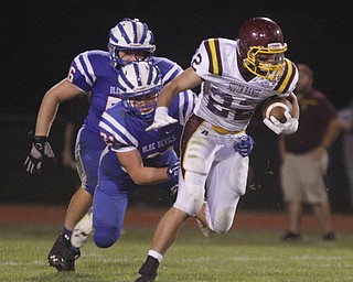       .         ROBERT  K. YOSAY | THE VINDICATOR..Raiders #22   Ethan Dominquez tries to elude 321 Blue Devil Ed Smith and #56  T J Henry..South Range at Western Reserve ...-30-