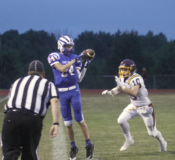       .         ROBERT  K. YOSAY | THE VINDICATOR..Blue Devil #24 Kade Hilles catches a sidelin e pass for a first down as Raiders #10 Greg Dunham can only watch..South Range at Western Reserve ...-30-