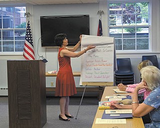 Christine Mabon presented her workshop “The 5 Essential Friendships that Enrich Our Lives” at the Salem Library earlier this month. At the event, she explained the five important friendships in our lives and associated them with the five courses of a meal. Above, Barbara Yonker, Wanda Spatz and Carolyn Oberle of Salem listen as Mabon introduced the five types of friendships and what course each friendship associated with. Photo by Crystal Beiersdorfer | The Vindicator 
