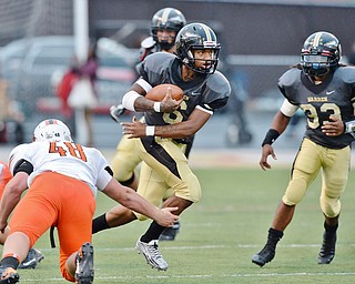Jeff Lange | The Vindicator  SEPTEMBER 11, 2015 - Harding quarterback Lynn Bowden (6) rushes past a leg tackle by Massillon's Dakota Dunwiddle (48) as Harding teammate Keemari Murry (33) trails from behind during first quarter action of their Friday night football game in Warren.