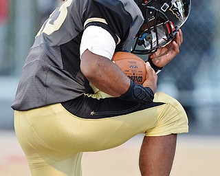 Jeff Lange | The Vindicator  SEPTEMBER 11, 2015 - Keemari Murry of Warren Harding kneels in the end zone in a moment of thankful prayer after scoring the second touch down of the Raiders' game against the Massillon Tigers, Friday night.
