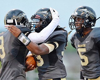 Jeff Lange | The Vindicator  SEPTEMBER 11, 2015 - Harding's Keemari Murry (center) celebrates with teammates Marlin Richardson .(3) and Dakota Shelton (5) after scoring a touch down in the first quarter of the Raiders' game against Massillon, Friday night in Warren.