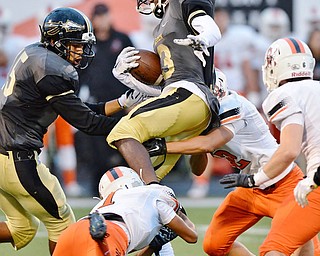 Jeff Lange | The Vindicator  SEPTEMBER 11, 2015 - Warren Harding's Marlin Richardson (center) is tackled by a host of Massillon defenders in the first half of their game in Warren on Friday night.