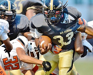 Jeff Lange | The Vindicator  SEPTEMBER 11, 2015 - Warren Harding's Keemari Murry (33) is tackled by Massillon's Kordell Ford (32) as he rushes for a touch down in the second quarter of Friday night's game in Warren.