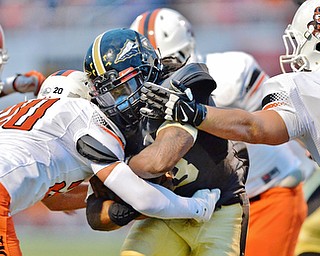 Jeff Lange | The Vindicator  SEPTEMBER 11, 2015 - Keemari Murry of Harding (center) is tackled by Dillon DeLong (20) as he rushes through a gauntlet of Massillon defenders during a two-point conversion attempt in the second quarter of Friday night's game in Warren.